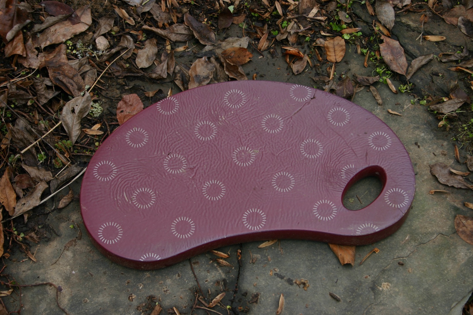 A padded garden kneeling pad on the ground
