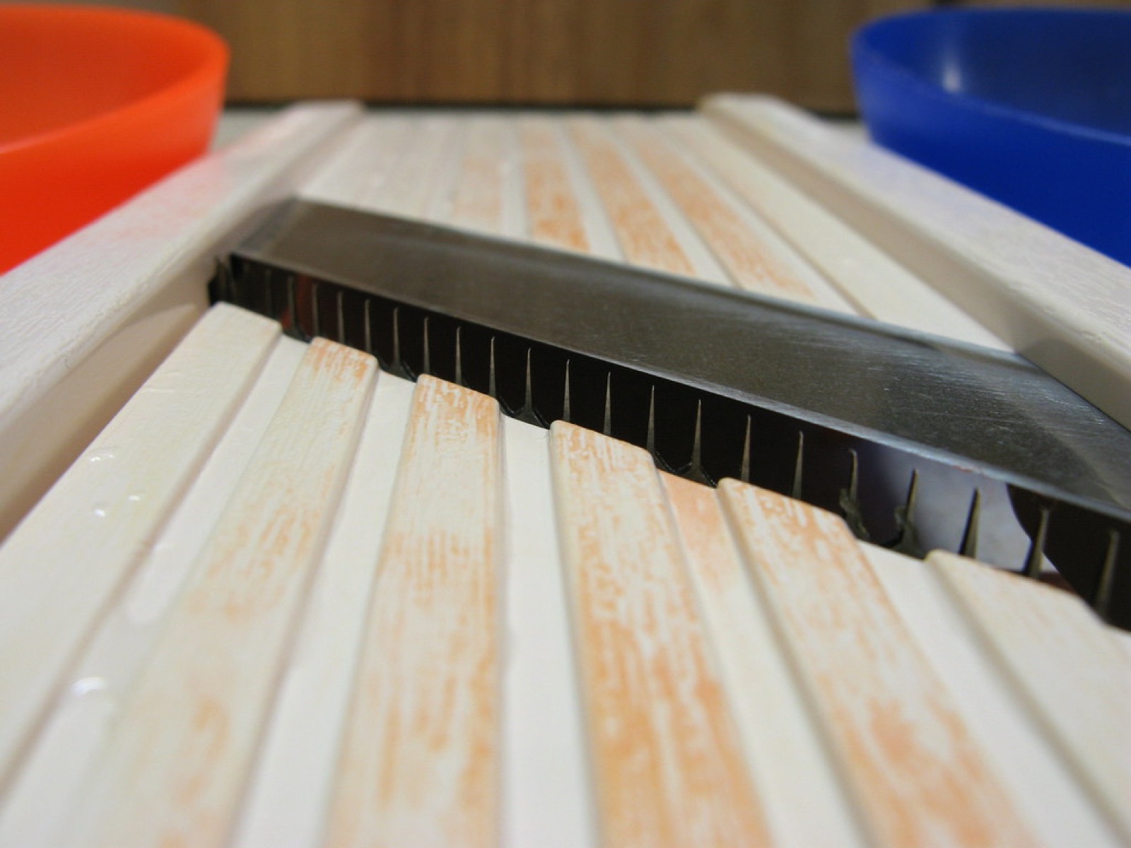 A stainless mandoline slicer on a kitchen table