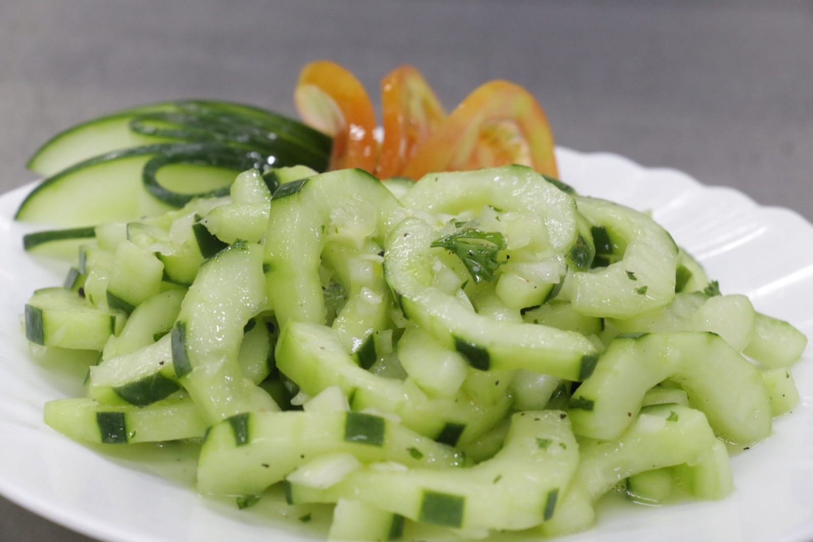 A plate of fresh cucumber salad with herbs