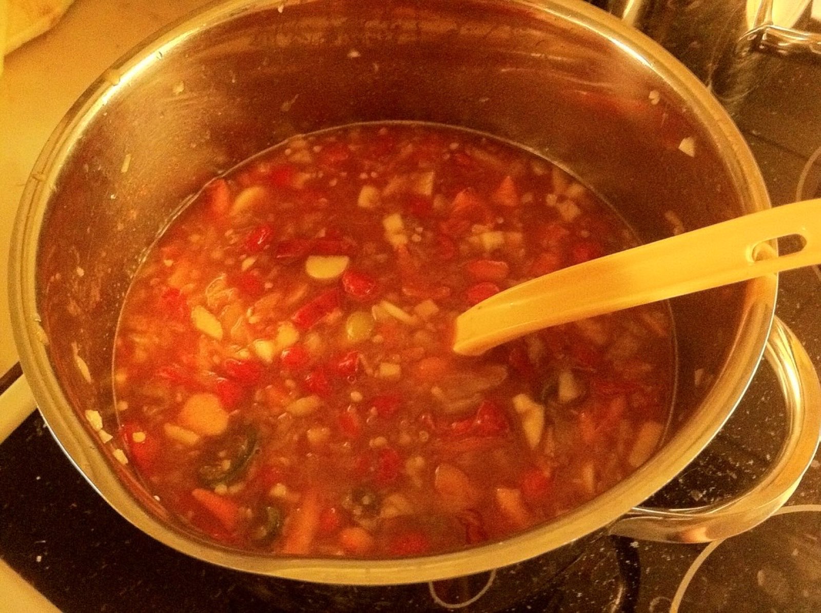 A pot of homemade tomato sauce simmering on the stove